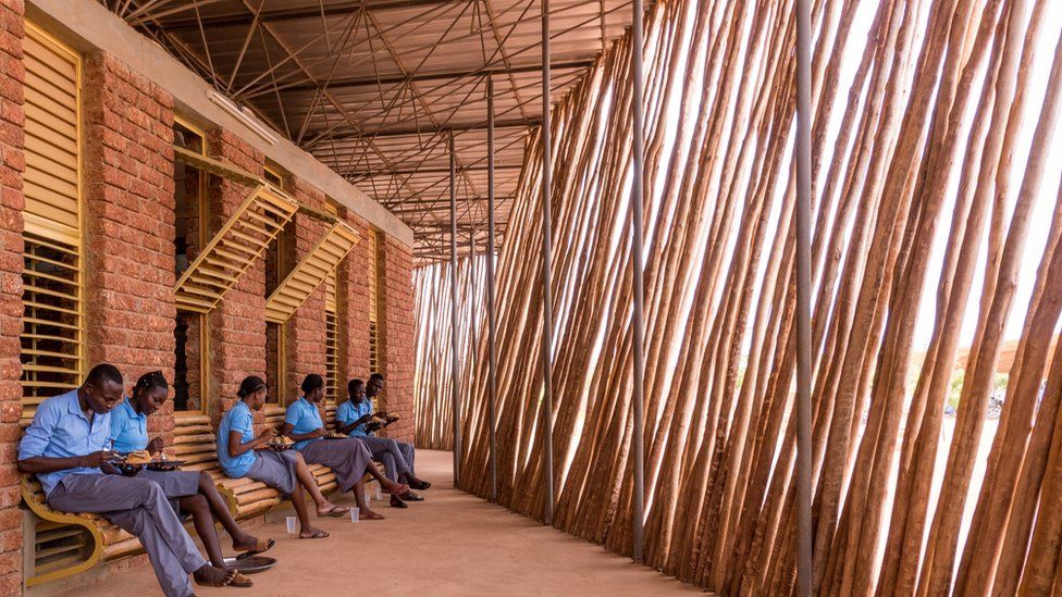 Children studying in a building by DIÉBÉDO FRANCIS KÉRÉ: The first African to win architecture’s top award - African Leaders Magazine 